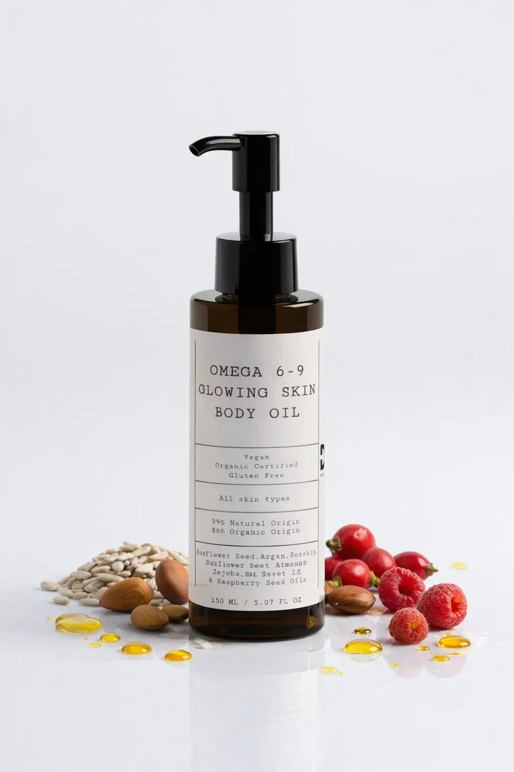 D.E.N. Omega 6-9 Glowing Skin Body Oil, amber pump bottle with nuts and red berries