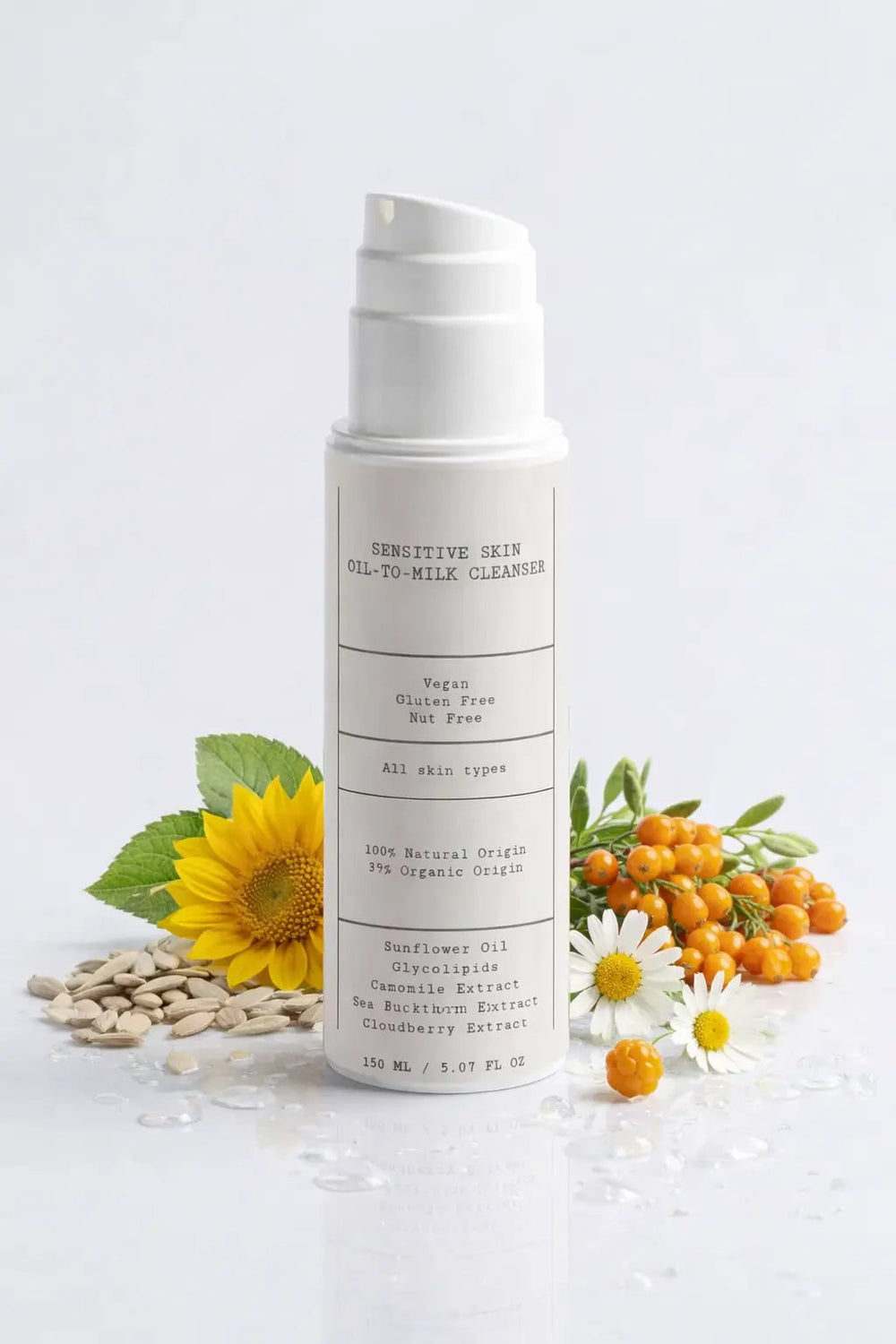 D.E.N. Sensitive Skin Oil-To-Milk Cleanser, white pump bottle with sunflower and sea buckthorn